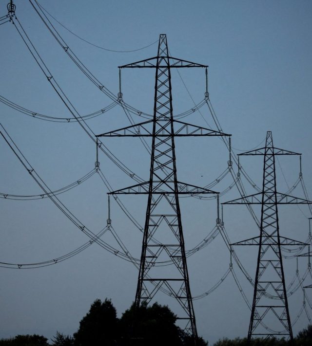 FILE PHOTO: A row of electricity pylons is seen near the Frodsham on shore wind farm in Frodsham, Britain, September 5, 2023. REUTERS/Phil Noble/File Photo