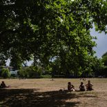 People sit in the shade at London Fields during a heat wave in London, UK, on Tuesday, July 1, 2025. Unusually hot weather is making it almost unbearable to travel on the UK capitals underground train network. Photographer: Jose Sarmento Matos/Bloomberg via Getty Images
