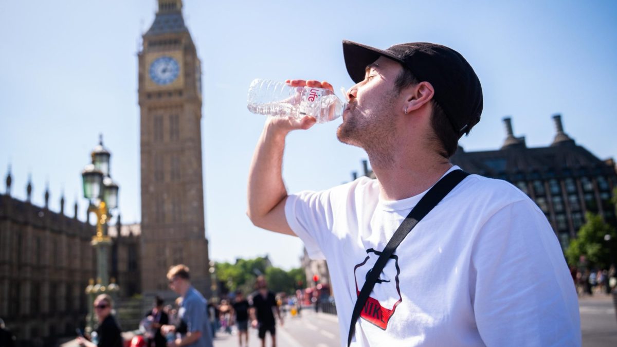 A man cools down with a bottle of water during the hot weather in Westminster Bridge, central London. The UK has recorded its all-time hottest May temperature as a part of London hit 33.5C on Bank Holiday Monday. Picture date: Monday May 25, 2026. PA Photo. The Met Office has said heatwave conditions were met in eight parts of England on Sunday - Heathrow in Greater London, Benson in Oxfordshire, Brooms Barn in Suffolk, High Beech in Essex, Kew Gardens in London, Northolt in London, Santon Downham in Suffolk and Writtle in Essex. Photo credit should read: James Manning/PA Wire