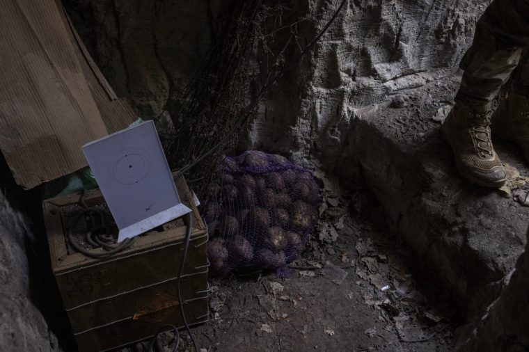 AVDIIVKA, UKRAINE - OCTOBER 23. A Starlink wifi terminal stands next to a sack of potatoes at the entrance to a trench at an artillery position manned by Ukraine's 59th Brigade around 8km the Avdiivka front line on 23rd October 2023, in Donetsk Region, Ukraine. Ukrainian defences are coming under increased pressure as Russia's military drives to capture the destroyed city of Avdiivka. (Photos by Ed Ram/For The Washington Post via Getty Images)