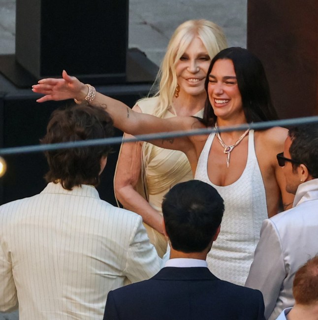 Singer Dua Lipa greets a guest next to designer Donatella Versace during wedding festivities following Lipa???s marriage to actor Callum Turner, in Palermo, Italy, June 5, 2026. REUTERS/Igor Petyx