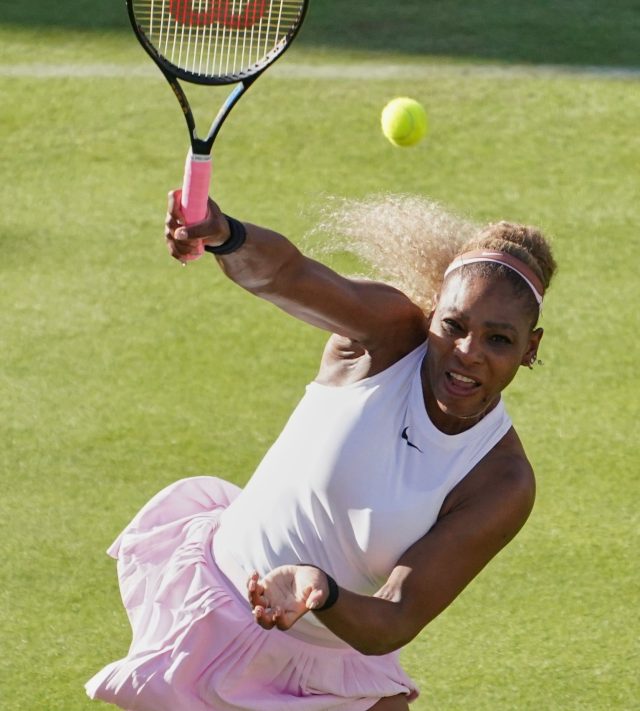 Serena Williams of the United States, hits a return as she and playing partner Victoria Mboko of Canada play against Nicole Melichar-Martinez of Canada and Erin Routliffe of New Zealand during their first round doubles match at the Queen's Club tennis championships in London, Tuesday, June 9, 2026. (AP Photo/Alberto Pezzali)
