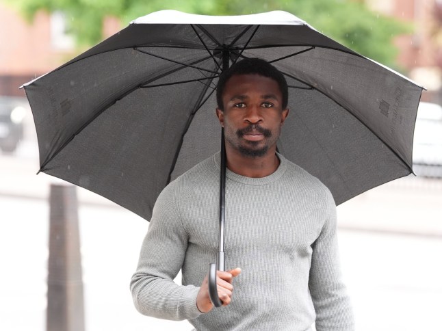 Michael Dome-Bemwin arrives at Westminster Magistrates' Court, central London, while holding an umbrella. (Picture: PA)