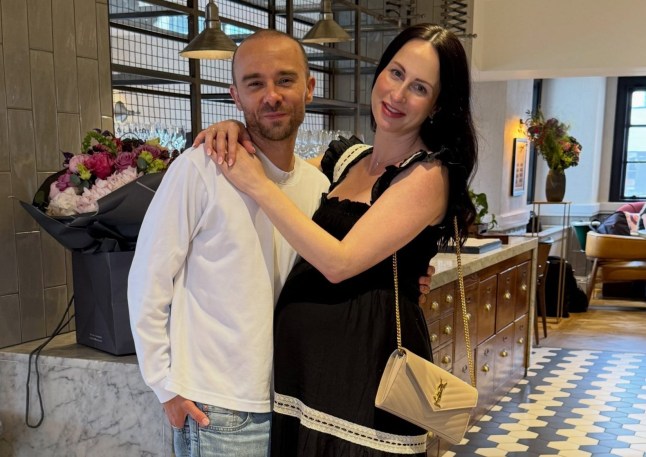 Jack P Shepherd and wife Hanni Treweek hugging while having their photo taken.