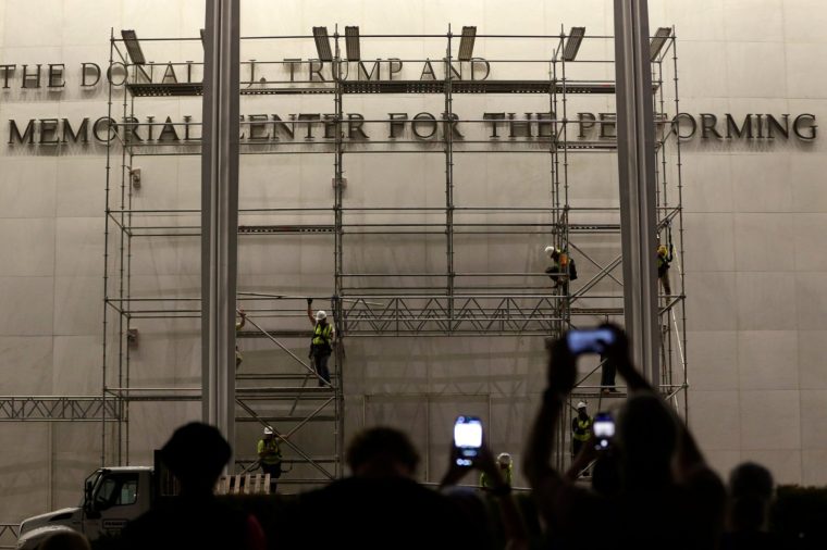 Workers construct scaffolding below the sign for the John F. Kennedy Center for the Performing Arts, Friday, June 12, 2026, in Washington. (AP Photo/Rahmat Gul)