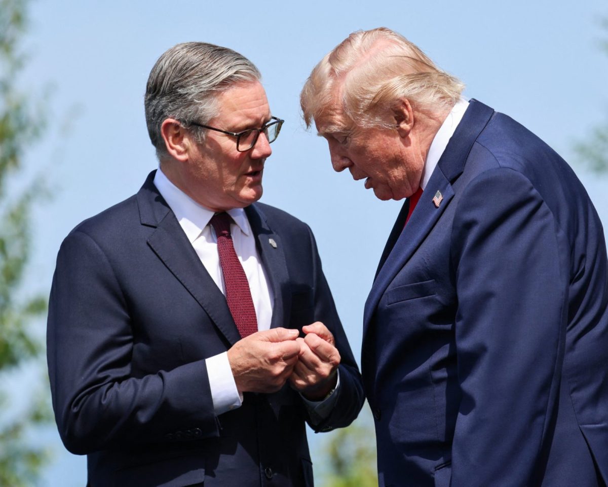 Britain's Prime Minister Keir Starmer and US President Donald Trump speak during a family photograph during the G7 summit, in Evian, eastern France, on June 16, 2026. A G7 summit is set to take place June 15 to 17 in the French town of Evian-les-Bains near Switzerland and it will be attended by country leaders as well as the EU's foreign policy chief and ministers from Brazil, Canada, the United Arab Emirates and Turkey. (Photo by Ludovic MARIN / POOL / AFP via Getty Images)