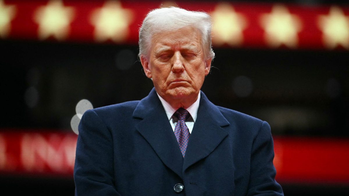 US President Donald Trump closes his eyes as he observes a moment of silence for firefighter Corey Comperatore who was killed during the assassination attempt on Donald Trump, during the inaugural parade inside Capital One Arena, in Washington, DC, on January 20, 2025. (Photo by Jim WATSON / AFP via Getty Images)