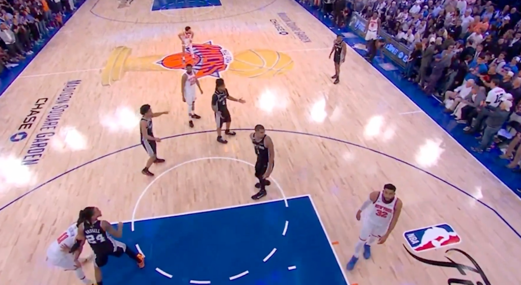 Basketball players on a court during a game.