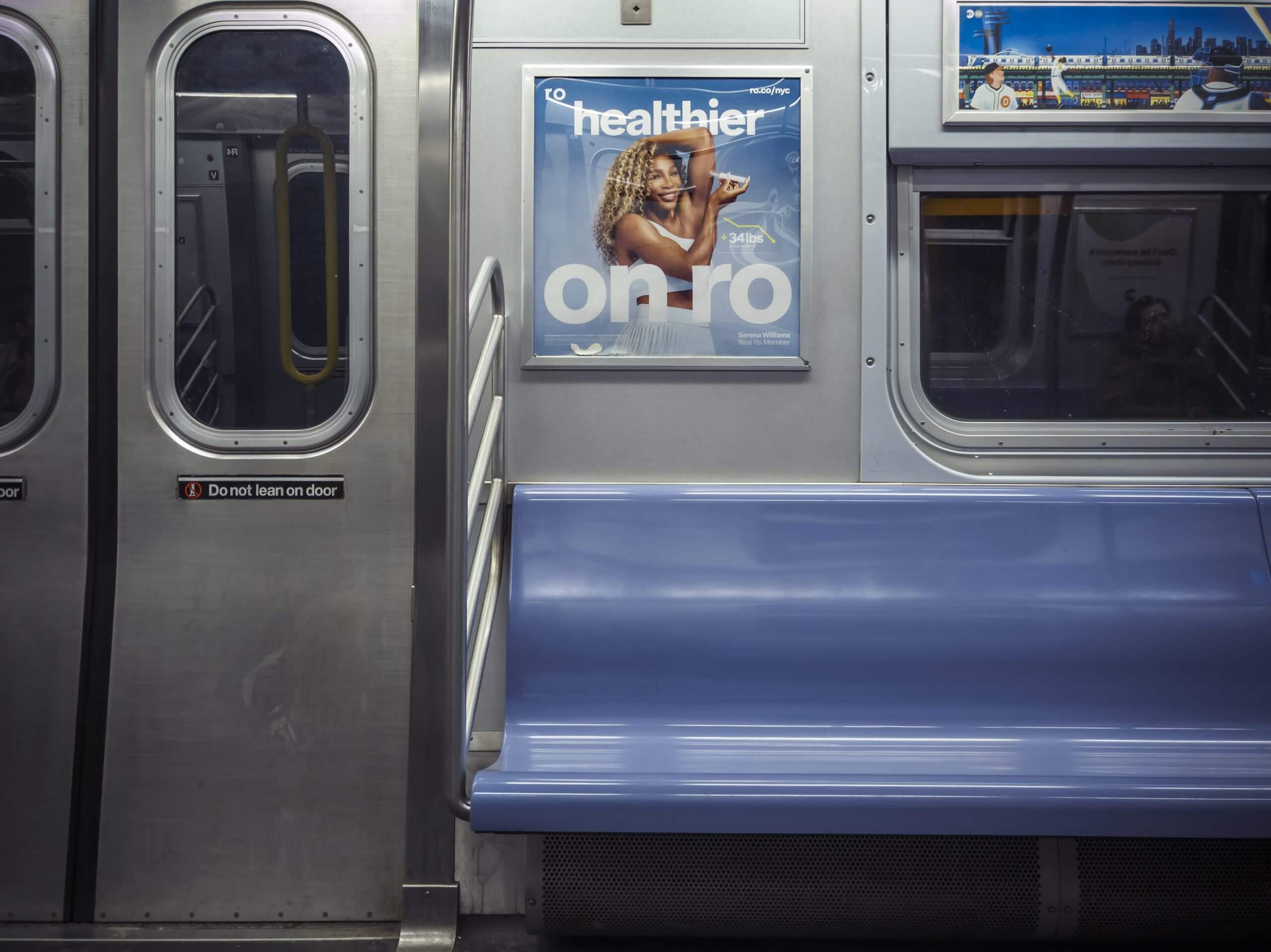 A New York subway car, empty, with a poster depicting Serena Williams injecting herself with a GLP-1 drug.