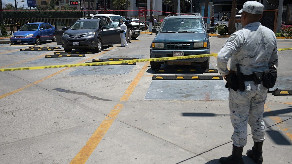 Forensic workers inspect a car where a body was allegedly found at a parking lot close to Caliente stadium, where Iran's national football team trains, in Tijuana, Baja California, Mexico on June 12, 2026.