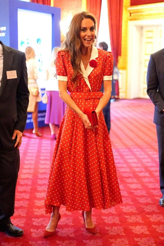 Princess Kate in a red dress smiling