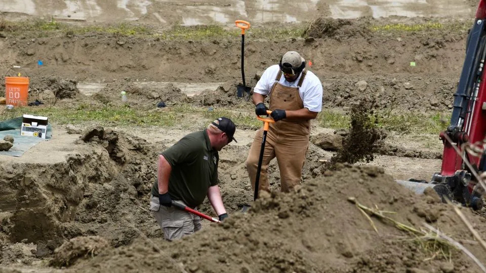 Sheriff’s investigators dig for dog carcasses on the grounds of Miranda’s Rescue on Wednesday. - Ryan Burns/Lost Coast Outpost