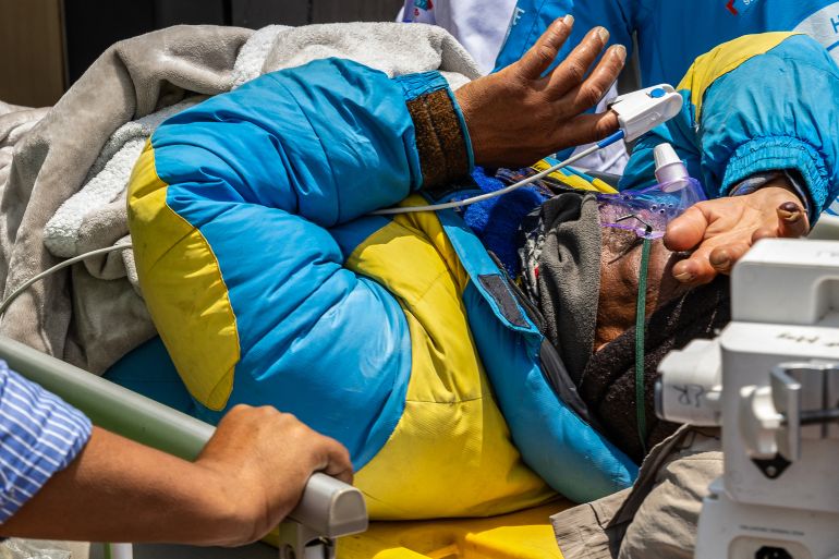 Mountaineer Dawa Sherpa is being carried by medics and rescuers upon his arrival at the HAMS Hospital in Kathmandu on June 4, 2026.
