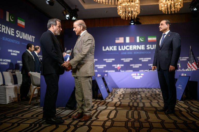 TOPSHOT - Iran's Foreign Minister Abbas Araghchi (L) shakes hands with Pakistan's Prime Minister Muhammad Shehbaz Sharif (C) next to Pakistan's Chief of Army Staff Field Marshal Asim Munir (R) prior to a quadrilateral meeting between the United States, Iran, Pakistan and Qatar at the Burgenstock luxury hotel complex overlooking Lake Lucerne, Switzerland, on June 21, 2026, as part of high-level talks aimed at advancing a deal to end the Middle East conflict.