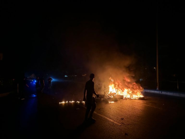 Hezbollah supporters block the old airport road in the southern suburbs of Beirut, with burning tires to protest against the trilateral agreement that was signed between the US, Israel and Lebanon on June 27, 2026. (Photo by Ibrahim AMRO / AFP)