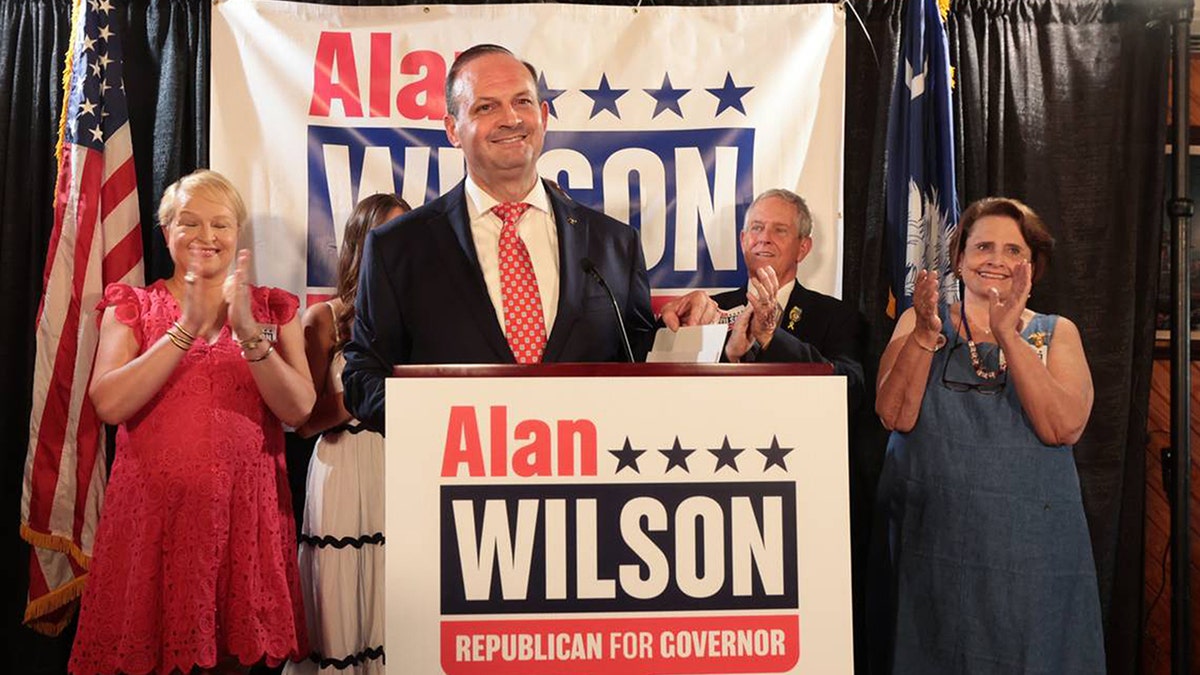 South Carolina Attorney General Alan Wilson speaking with his family at a podium