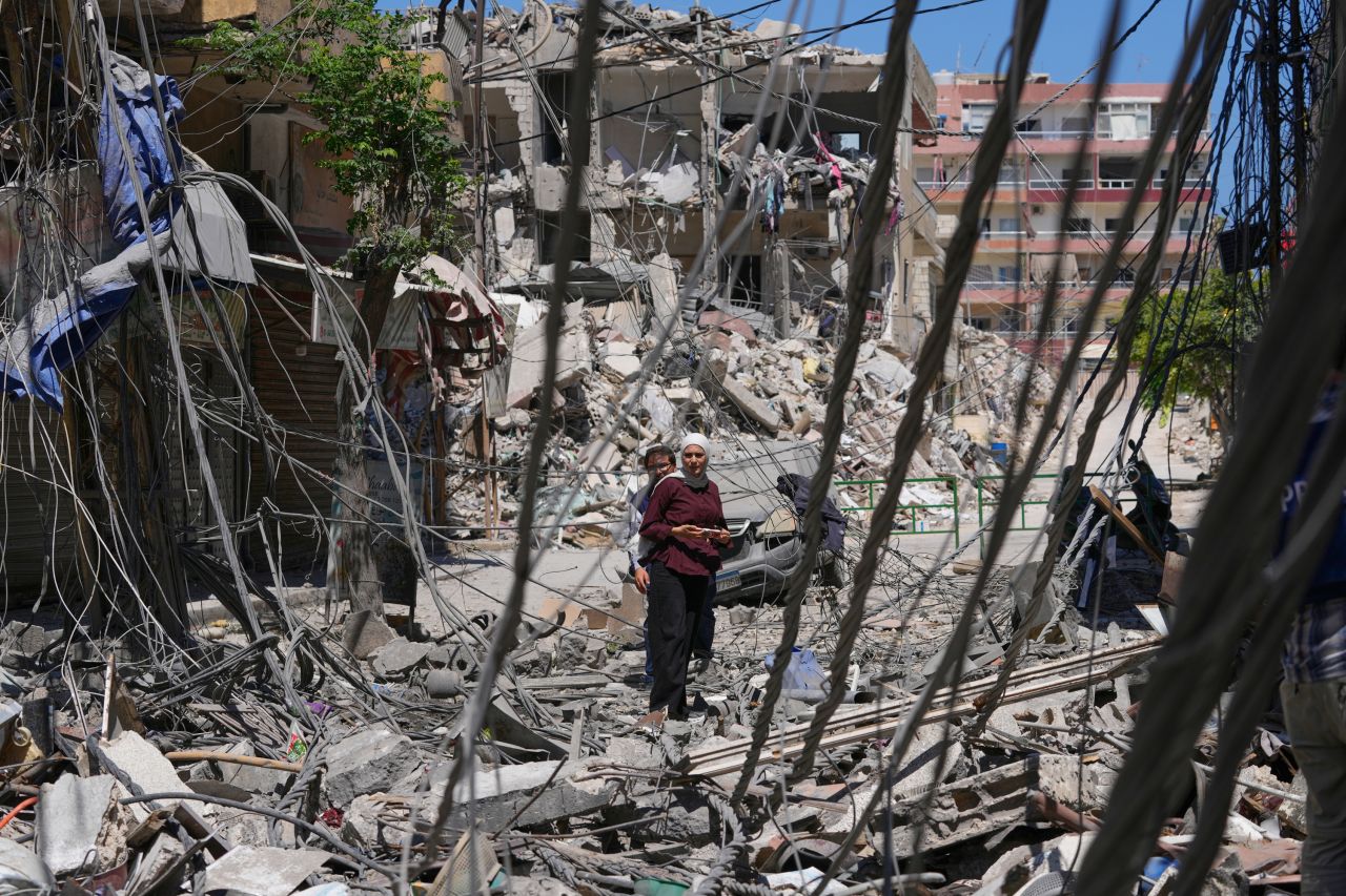 People check destroyed buildings that were hit recently in an Israeli airstrike in the southern port city of Tyre, Friday.