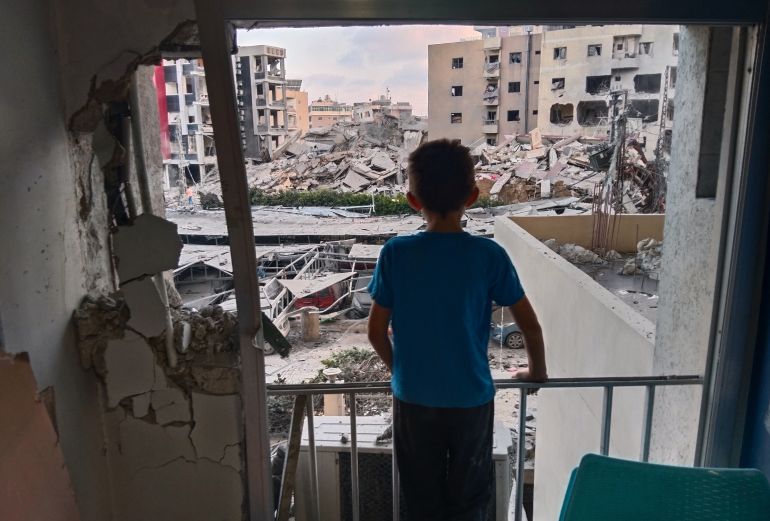 A boy looks through a damaged room of the Jabal Amel Hospital into a destroyed building that was hit in an Israeli airstrike in the southern port city of Tyre, Lebanon, Monday, June 1, 2026. (AP Photo)