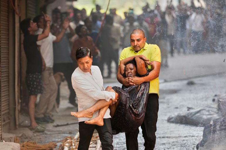 Local people rescue a foreign national from a hotel fire in New Delhi, India, Wednesday, June 3, 2026. (AP Photo/Manish Swarup)