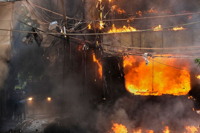 Fire officials douse a fire at a hotel in New Delhi, India, Wednesday, June 3, 2026. (AP Photo/Manish Swarup)