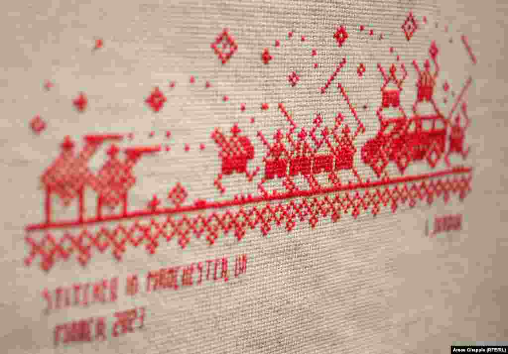 A detail of one panel showing protesters clashing with riot police in Brest.<br><br>Bazlova says the textile political art, which mimics the patterns used on traditional vyshyvanka shirts, is impactful precisely because it is not shocking. Unlike distressing documentary imagery of the postelection violence, cross-stitch depictions are "nice, even though they're speaking about hard topics," the artist told RFE/RL.<br><br><br><br><br>
