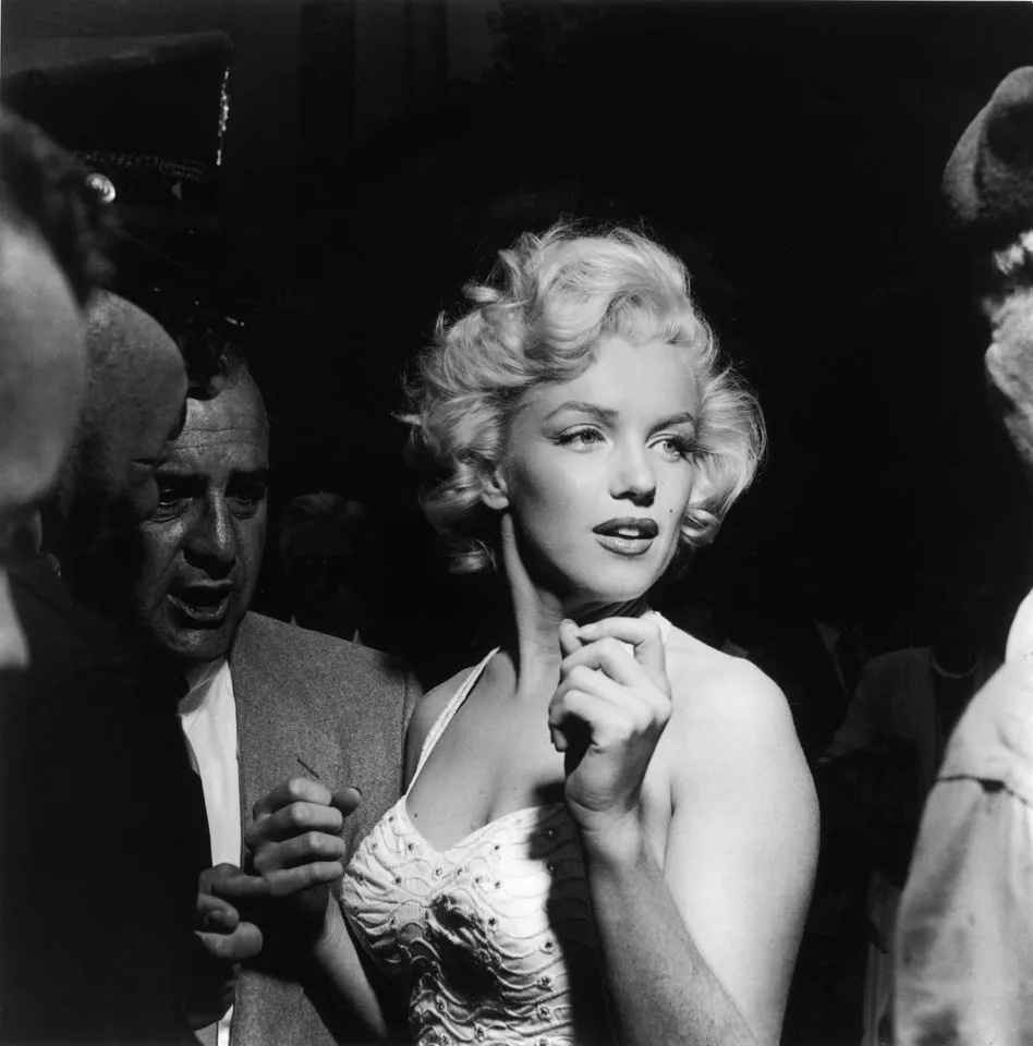 Marilyn Monroe surrounded by journalists and fans outside Grauman's Chinese Theater in Hollywood, California in 1953Credit: Getty Images