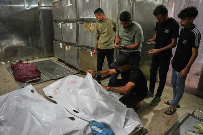 Gaza Strip Mourners take the last look at the bodies of two Palestinian girls Zeina Safadi, and her sister Lana, who were killed during an overnight Israeli airstrike that damaged their home, during their funeral in Gaza City, Saturday, June 20, 2026.
