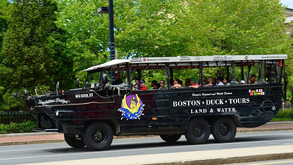 A Boston duck boat carrying tourists on water.