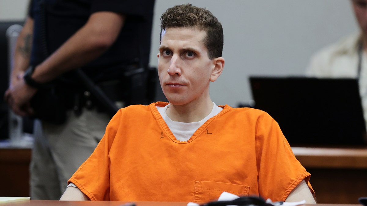 Bryan Kohberger sitting in an orange jumpsuit in a courtroom at Ada County Courthouse in Boise, Idaho