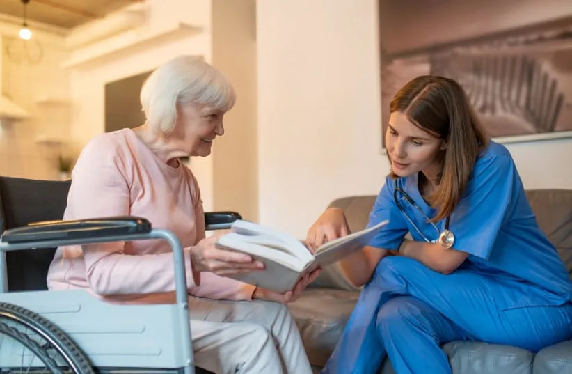 A medical professional with an elderly patient. (credit: SHUTTERSTOCK)