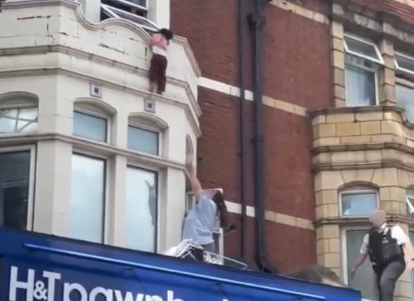Terrifying moment child hangs to ledge above London shop before dramatic rescue - London Evening Standard
