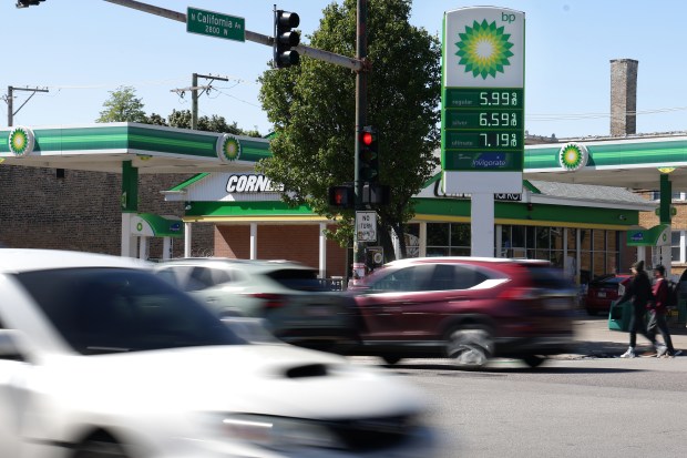 Vehicles pass a BP station advertising $5.999/gal for 87-octane fuel at California and Fullerton Avenues, May 11, 2026, in Chicago. (Terrence Antonio James/Chicago Tribune)