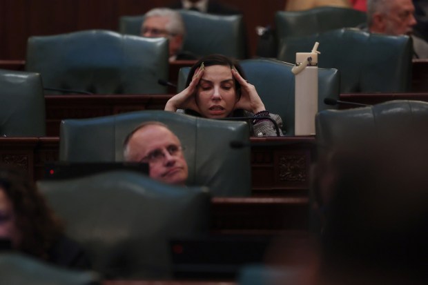 State Rep. Anne Stava rubs her temples and jaw muscles while listening to debate over the budget bill on the final night of the spring legislative session at the State Capitol early on June 1, 2026, in Springfield. (John J. Kim/Chicago Tribune)