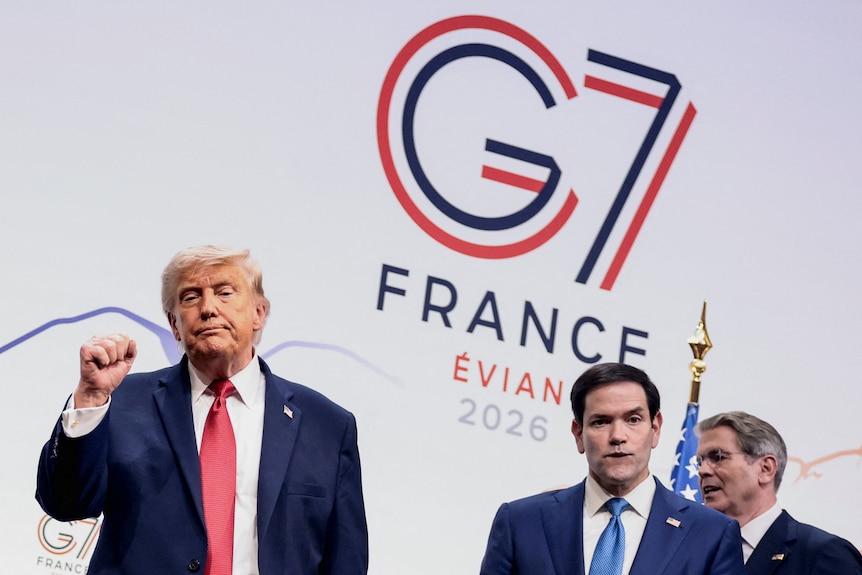 Trump with a defeated look on his face while making a fist