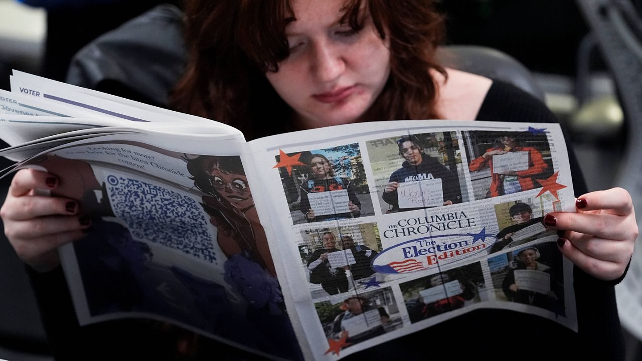 Columbia College Chicago student Kailey Ryan reads a newspaper in Chicago, Nov. 5, 2024. (AP Photo/Nam Y. Huh, File)