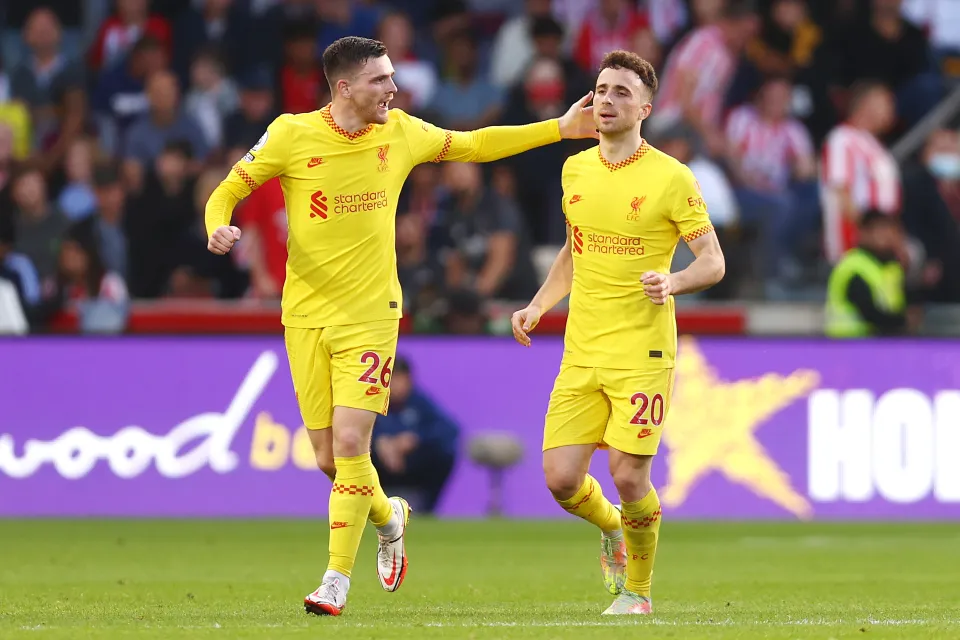 Diogo Jota of Liverpool celebrates scoring his sides first goal with Andrew Robertson during the Premier League match between Brentford and Liverpool