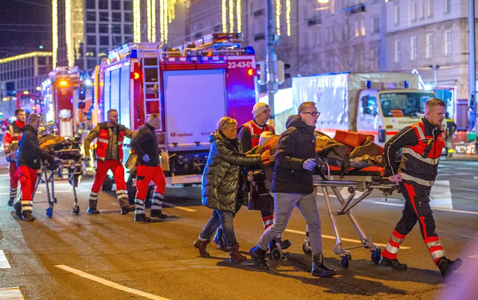 Ambulance crews ferry equipment on stretchers away annual Christmas market in the city center