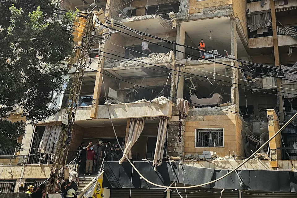 -/AFP via Getty Images - PHOTO: First responders inspect damage at the site of an Israeli airstrike on an apartment building in Beirut's southern suburbs, June 7, 2026.