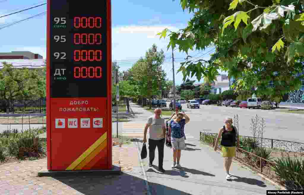 Pedestrians walk past a closed fuel station in Yevpatoriya on June 11.<br><br>In the Krasnodar region of Russia, local authorities have noted shortages exacerbated by drivers from Crimea allegedly filling up in the Russian region before returning to the peninsula.