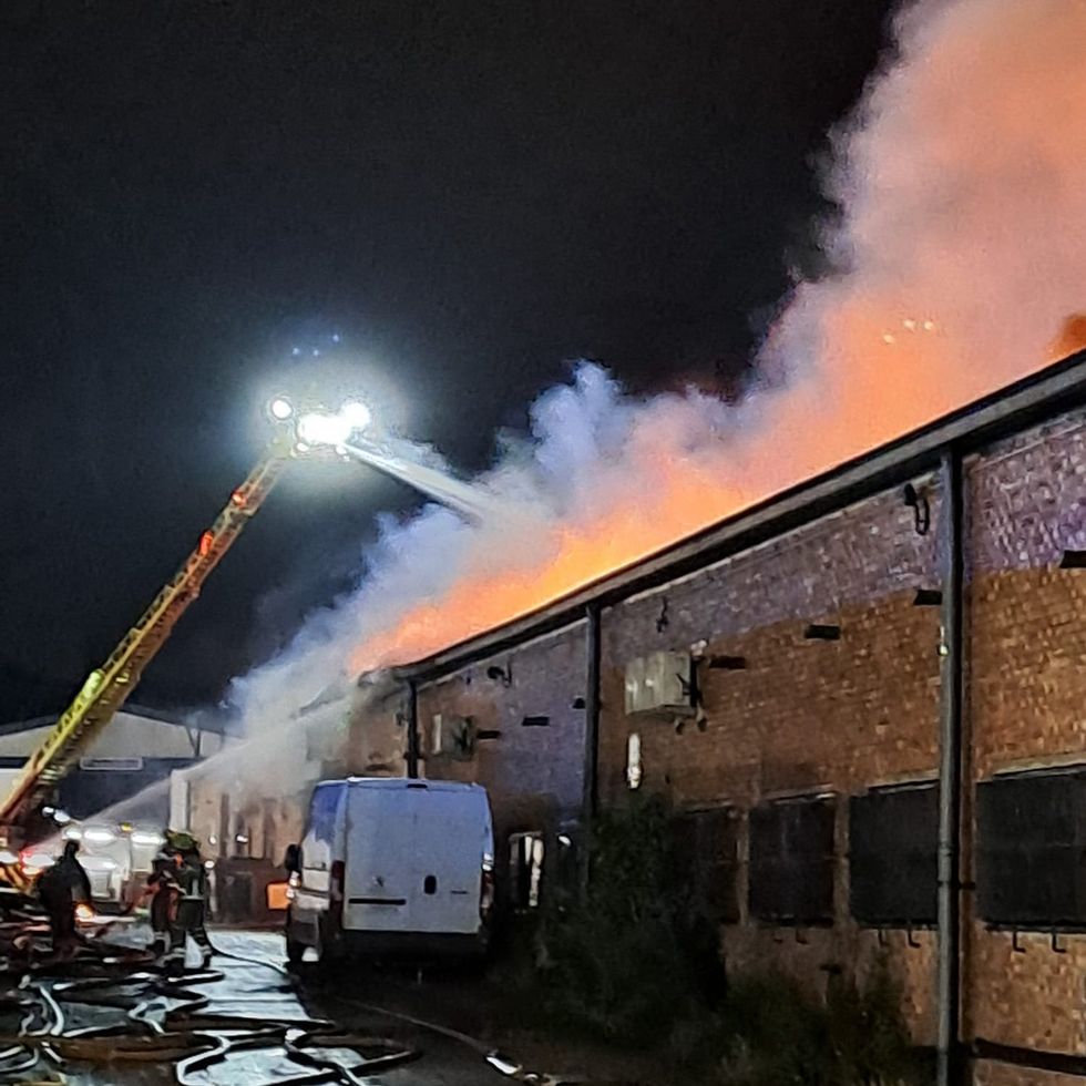 Firetruck putting out blaze in Oxgate Lane warehouse