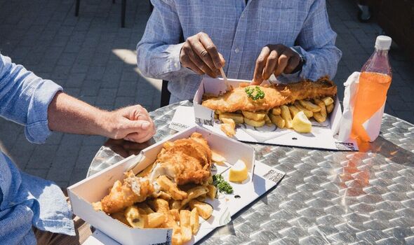 People enjoying fish and chips People enjoying fish and chips
