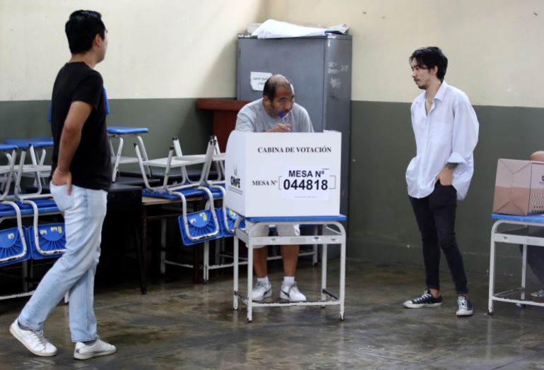 LIMA, PERU - APRIL 12: A sick voter casts his ballot in the company of his sons during the presidential election on April 12, 2026 in Lima, Peru. Peruvians, who were going to the polls to elect their ninth president in 10 years amid tensions and political unrest, have 35 candidates from which to choose. (Photo by Raul Sifuentes/Getty Images)