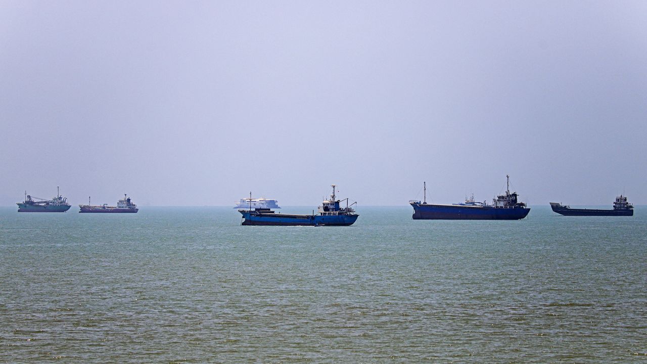TOPSHOT - In this picture obtained from Iran's ISNA news agency on June 18, 2026, vessels are seen anchored in Bandar Abbas along the Strait of Hormuz. Oil prices tumbled after Trump and his Iranian counterpart separately signed their accord to end the Middle East war, with the Strait of Hormuz to reopen but two months of negotiations lying ahead. (Photo by AMIRHOSSEIN KHORGOOEI / ISNA / AFP via Getty Images) /