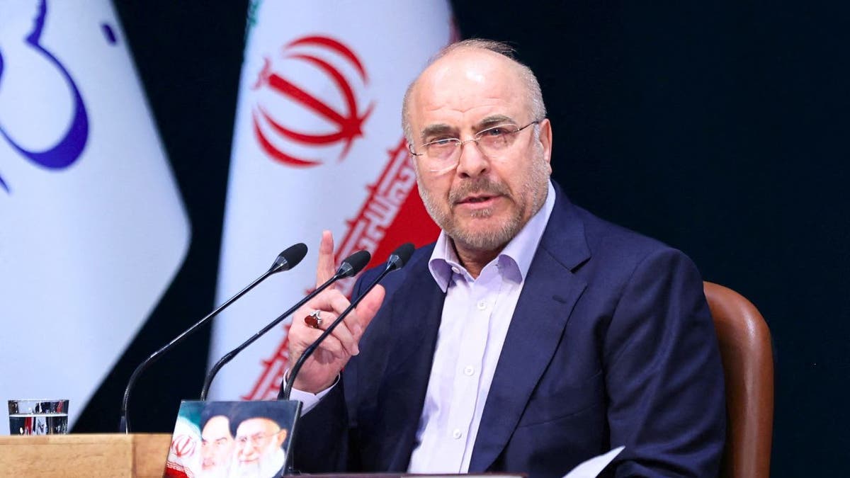 Iranian Parliament Speaker Mohammad Bagher Ghalibaf speaks during a press conference in Tehran, Iran in front of multiple flags