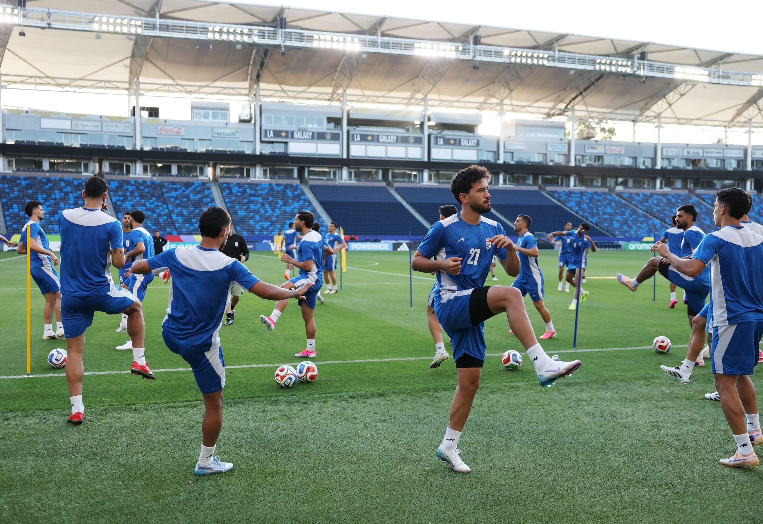 Iranian players stretching in a stadium