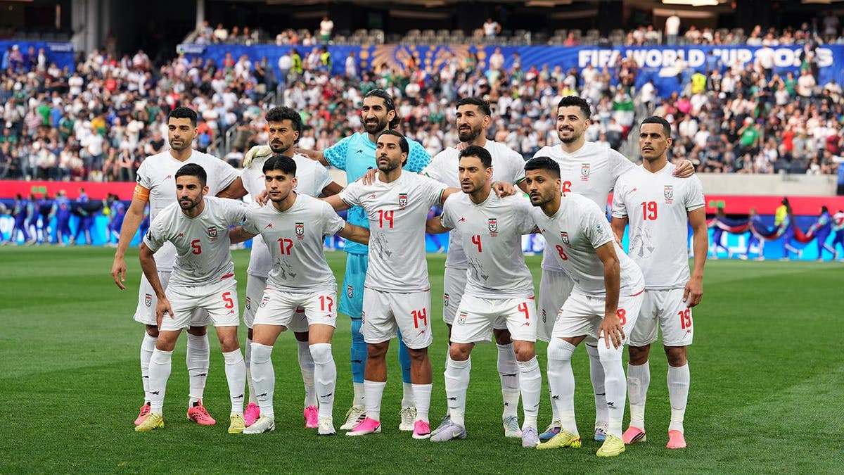 Team of Iran posing on the field at SoFi Stadium in Inglewood, California