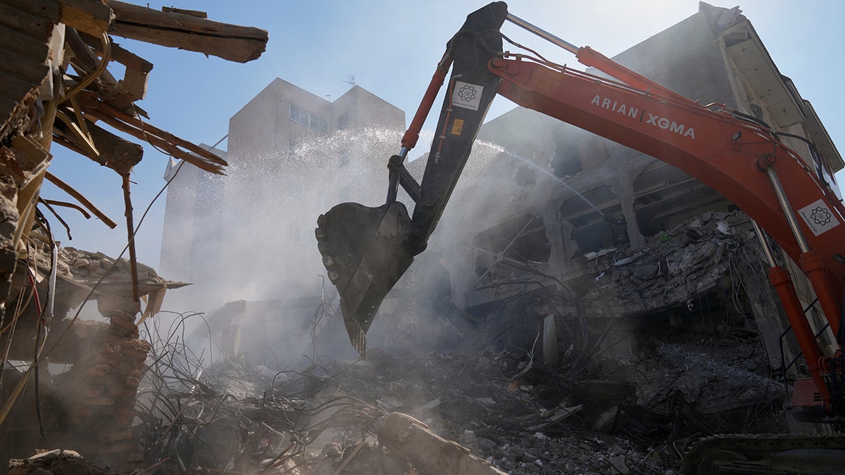 An excavator removing debris from a destroyed building in Tehran.