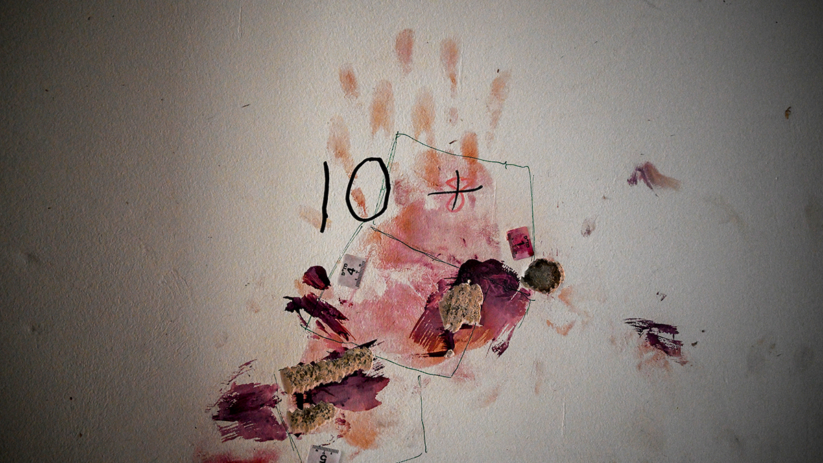 A bloodied handprint on a wall inside a house in Nir Oz kibbutz