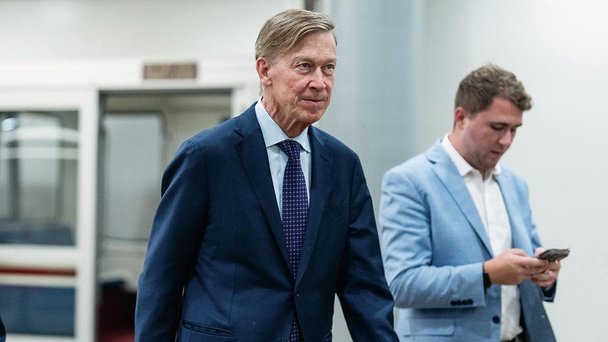 Senator John Hickenlooper walking in the Senate Subway of the US Capitol in Washington, D.C.