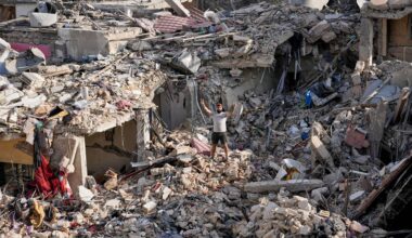 A man who returns to his village following the announcement of an initial ceasefire agreement between the United States and Iran, flashes victory sign as he stands on the rubble of his destroyed house in Nabatiyeh town, southern Lebanon, Tuesday, June 16, 2026. (AP Photo/Hussein Malla)